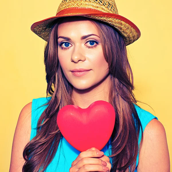 Woman in hat holding red heart — Stock Photo, Image