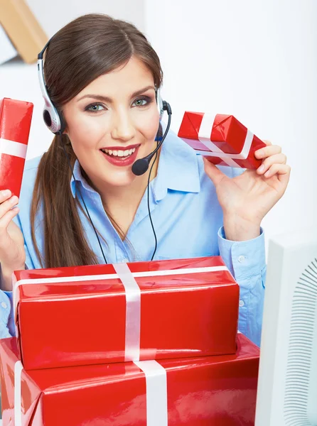 Smiling operator with red gift boxes — Stock Photo, Image