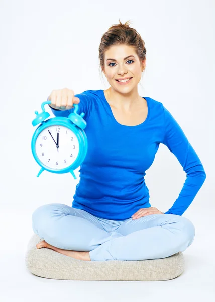 Smiling woman holding alarm clock — Stock Photo, Image