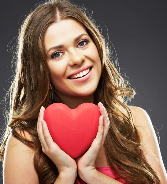 Smiling woman holding red heart — Stock Photo, Image