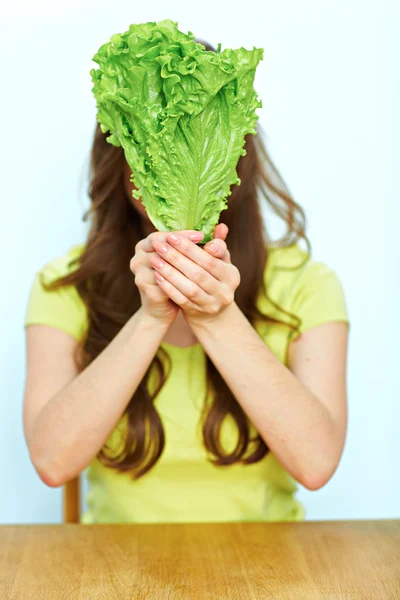 Woman holds green lettuce Stock Photo