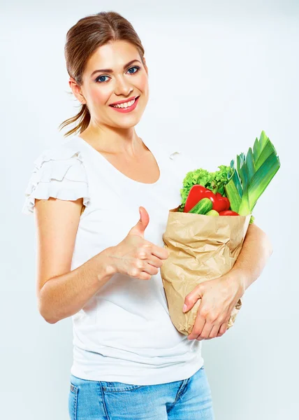 Woman holds bag with vegetables — Stock Photo, Image