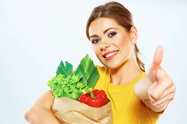 Woman holds bag with vegetables — Stock Photo, Image