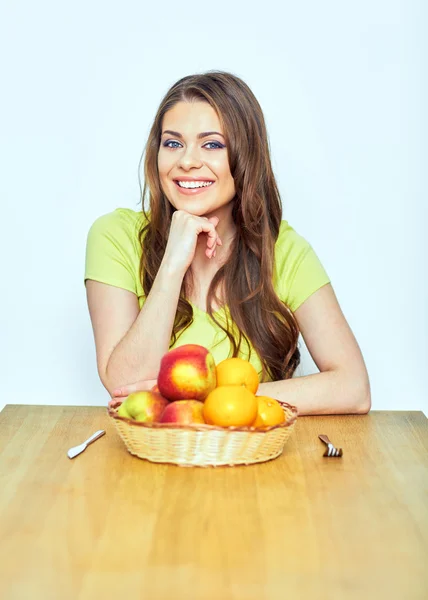 Gyümölcsök asztalnál ülő nő — Stock Fotó