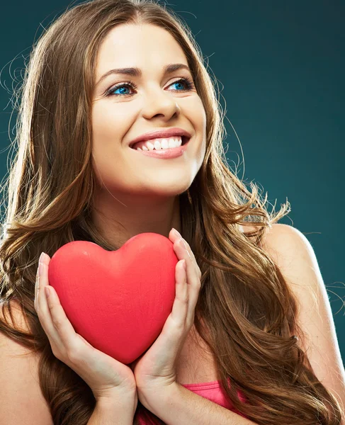 Smiling woman holding red heart — Stock Photo, Image