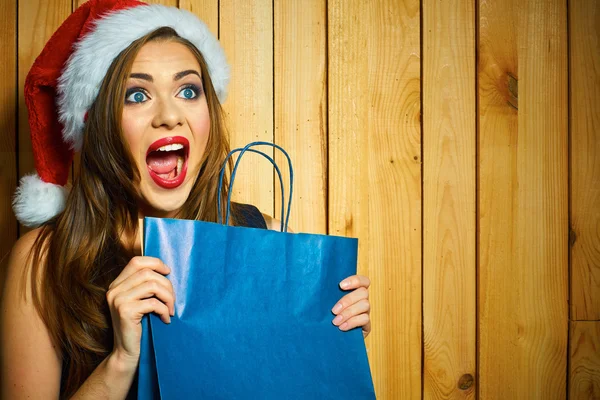 Santa girl holds shopping bag — Stock Photo, Image