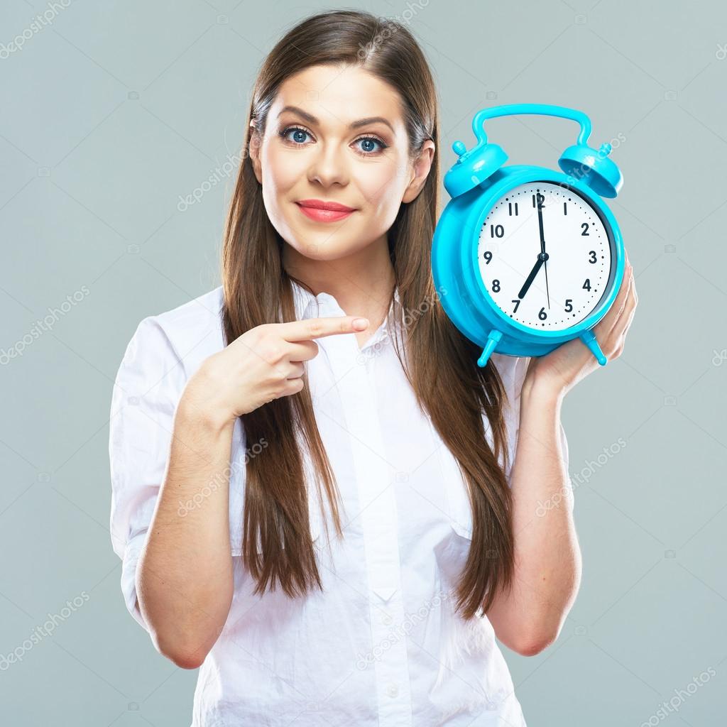 businesswoman holds alarm clock