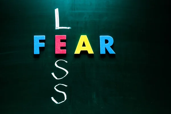 Less fear concept on blackboard — Stock Photo, Image