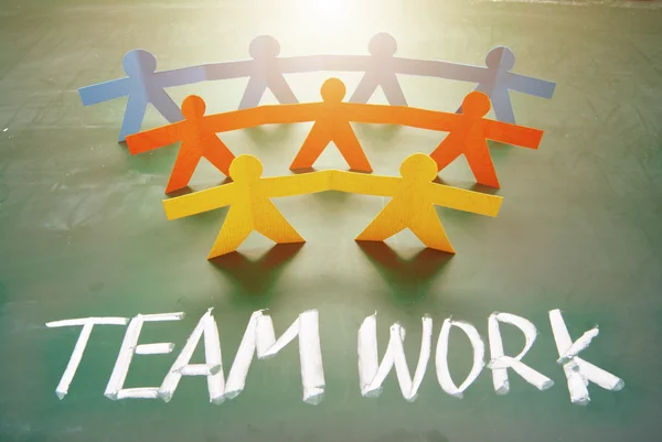 Teamwork words and colorful paper dolls — Stock Photo, Image