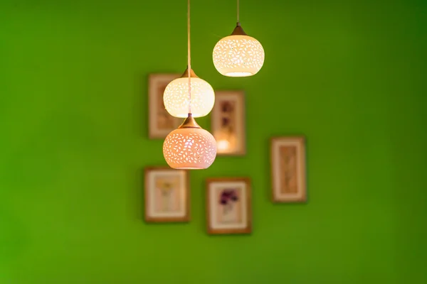 Hanging light and wooden photo frame on wall — Stock Photo, Image
