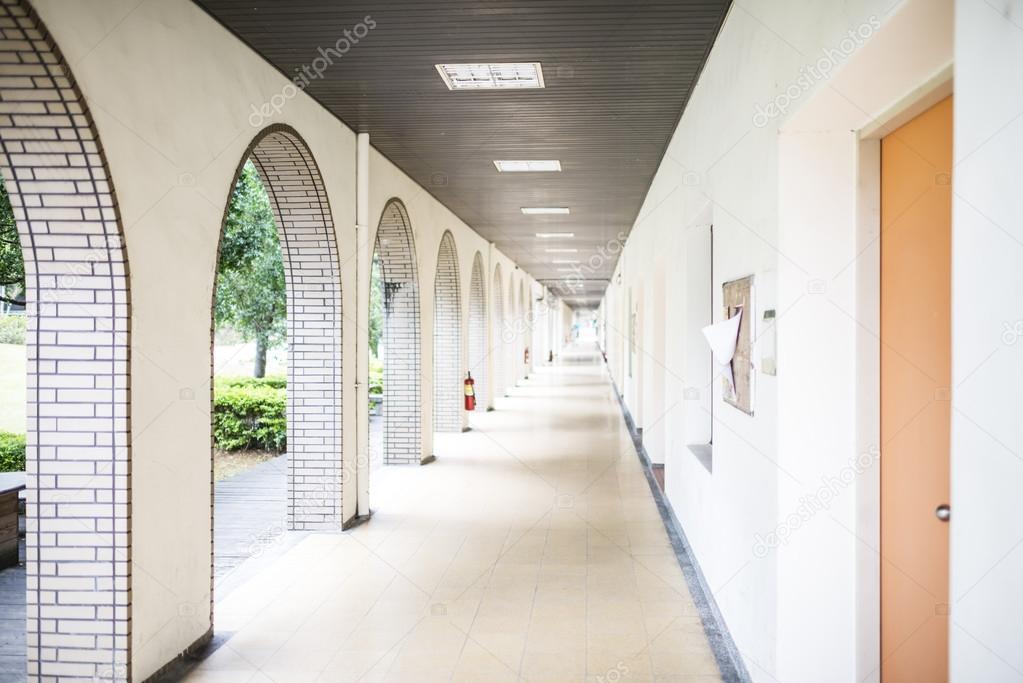 School long straight open-air passage lined with tiled white