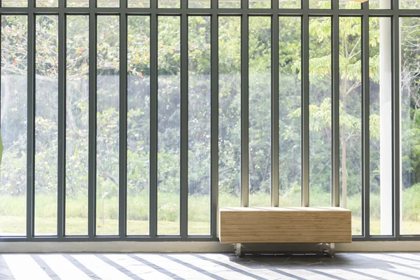 Wooden bench in front of French window with sunlight — Stock Photo, Image