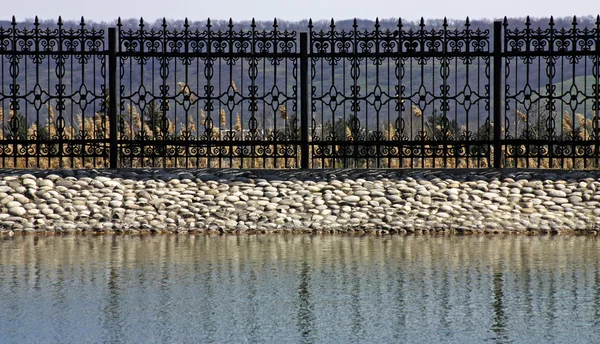 Metalen hek aan het oude meer — Stockfoto