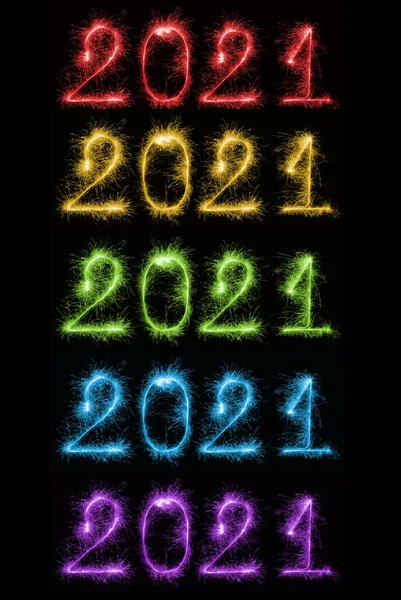 Set of colorful sparkling burning numbers Year 2021 on black background for design holiday web banner and greeting card. Numbers made of Bengal lights. Happy New Year 2021 theme.