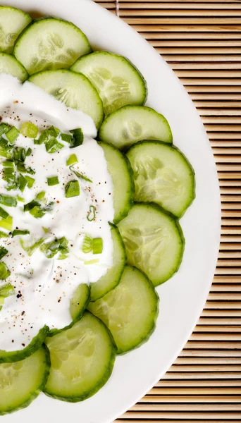 Fresh cucumber slices with sour cream — Stock Photo, Image