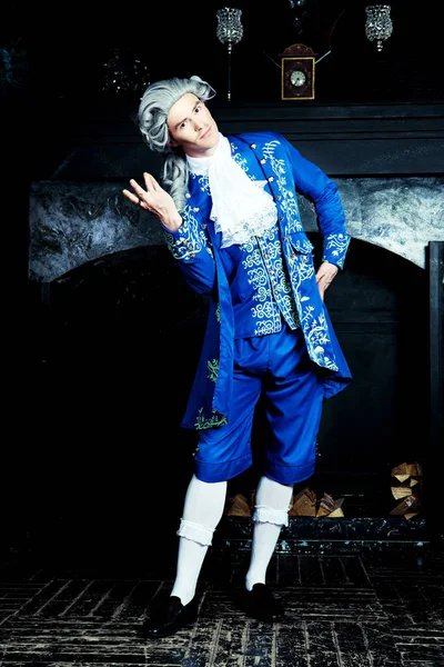 actor dressed as an aristocrat from the eighteenth century wearing a wig