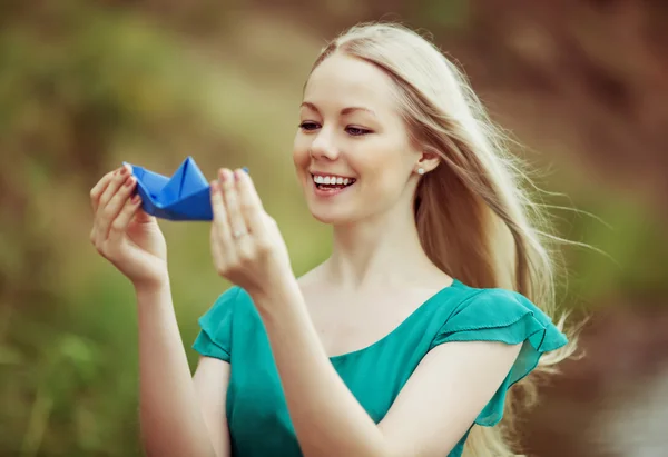Woman with a paper boat — Stock Photo, Image
