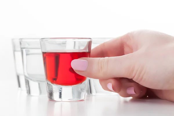 Female hand reaching for a glass of alcohol — Stock Photo, Image