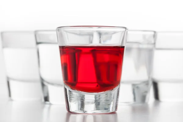 Glasses of alcohol on white background — Stock Photo, Image