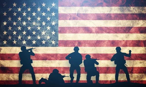 Soldiers in assault on USA flag. — Stock Photo, Image