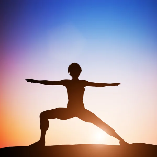Woman in warrior  yoga pose — Stock Photo, Image