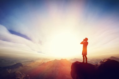 Man screaming on the top of the mountain. clipart