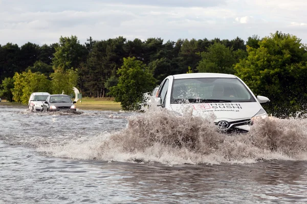 Cars trying to drive against flood — ストック写真