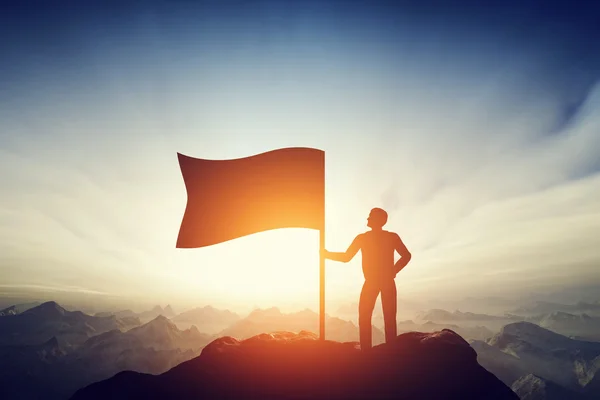 Proud man raising a flag — Stock Photo, Image