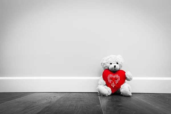 Cute teddy bear with plush heart — Stock Photo, Image