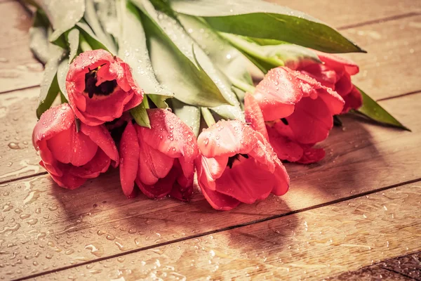 Μπουκέτο με λουλούδια φρέσκα κόκκινη τουλίπα σε ξύλο — Φωτογραφία Αρχείου