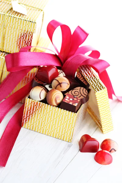 Box of chocolates with red ribbon — Stock Photo, Image