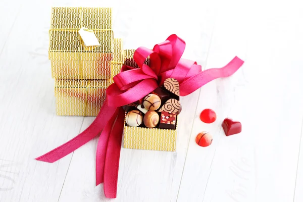 Box of chocolates with red ribbon — Stock Photo, Image