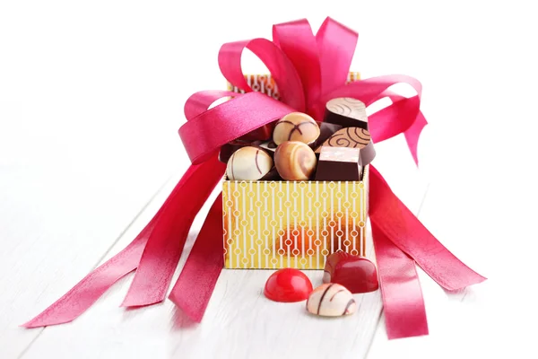 Box of chocolates with red ribbon — Stock Photo, Image