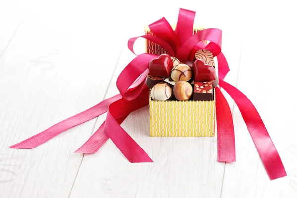 Box of chocolates with red ribbon — Stock Photo, Image