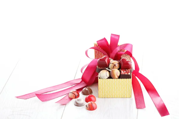 Box of chocolates with red ribbon — Stock Photo, Image