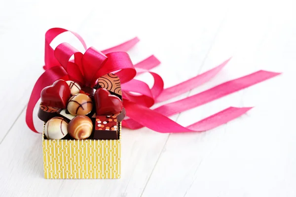 Box of chocolates with red ribbon — Stock Photo, Image