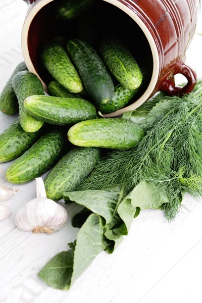 Lots of cucumbers on wooden table — Stock Photo, Image