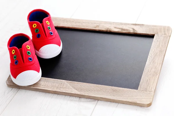 Frame and baby shoes advertisement — Stock Photo, Image