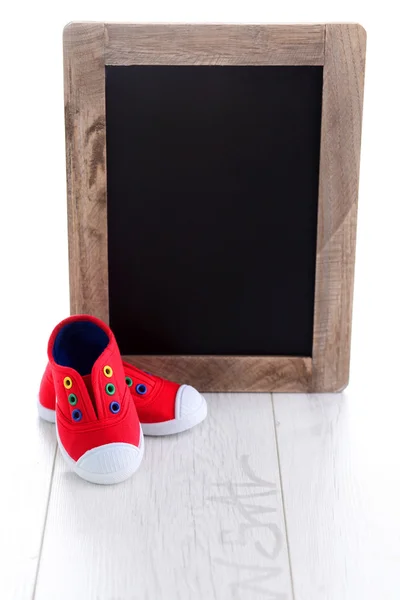 Frame and baby shoes advertisement — Stock Photo, Image