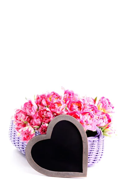 Muitas tulipas rosa com coração — Fotografia de Stock