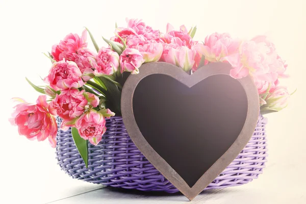 Lots of pink tulips with heart — Stock Photo, Image