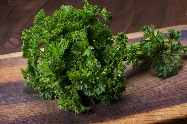 Fresh parsley on wooden table — Stock Photo, Image