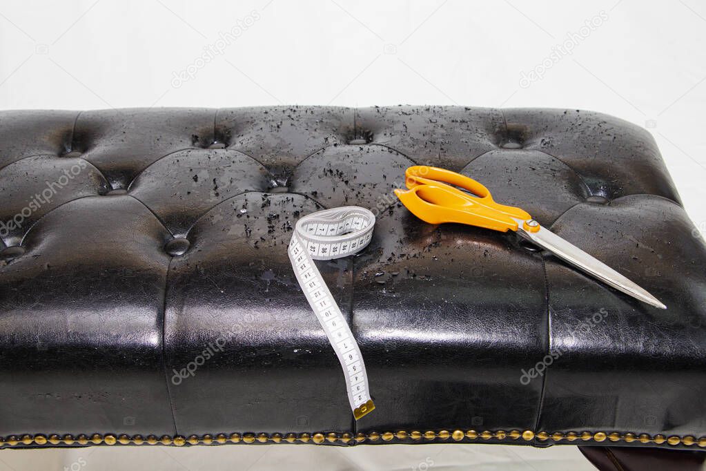 black leather background with damaged surface, furniture repair.
