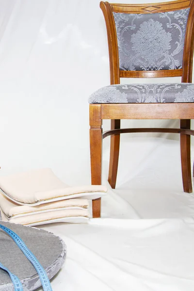 Vintage furniture: restoration of old chairs, replacement of upholstery. On a light background