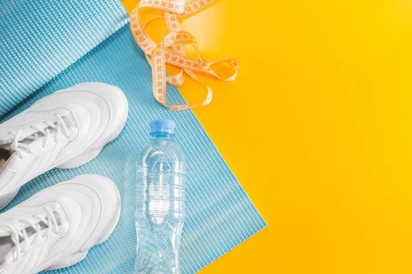 Yoga Mat, sports shoes, water bottle, the concept of a healthy lifestyle