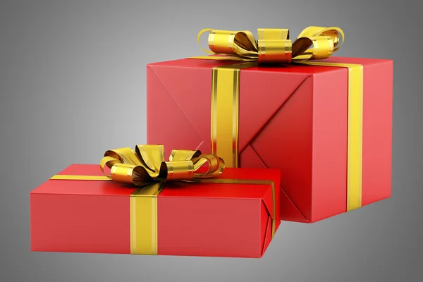 Two red gift boxes with golden ribbons isolated on gray backgrou — Stock Photo, Image