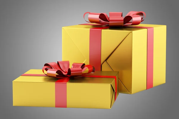 Dos cajas de regalo amarillas con cintas rojas aisladas sobre fondo gris — Foto de Stock