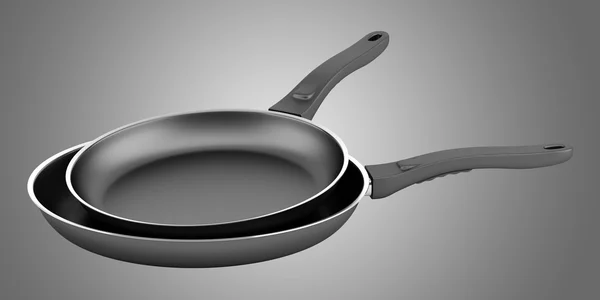 Two fryer pans isolated on gray background — Stock Photo, Image