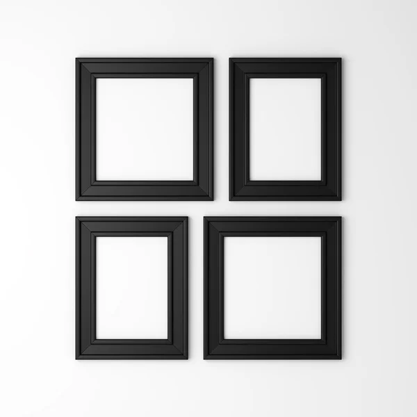 Four blank black photo frames on white wall — Stock Photo, Image