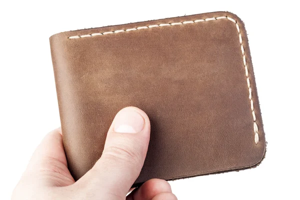 Brown leather wallet in hand isolated on white background — Stock Photo, Image